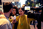 Protestor talking to journalist on the street.